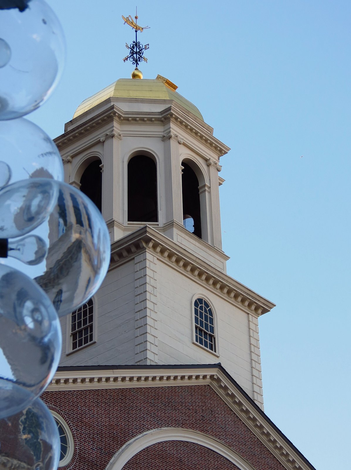 The bell tower and golden cupola of Faneuil Hall in Boston