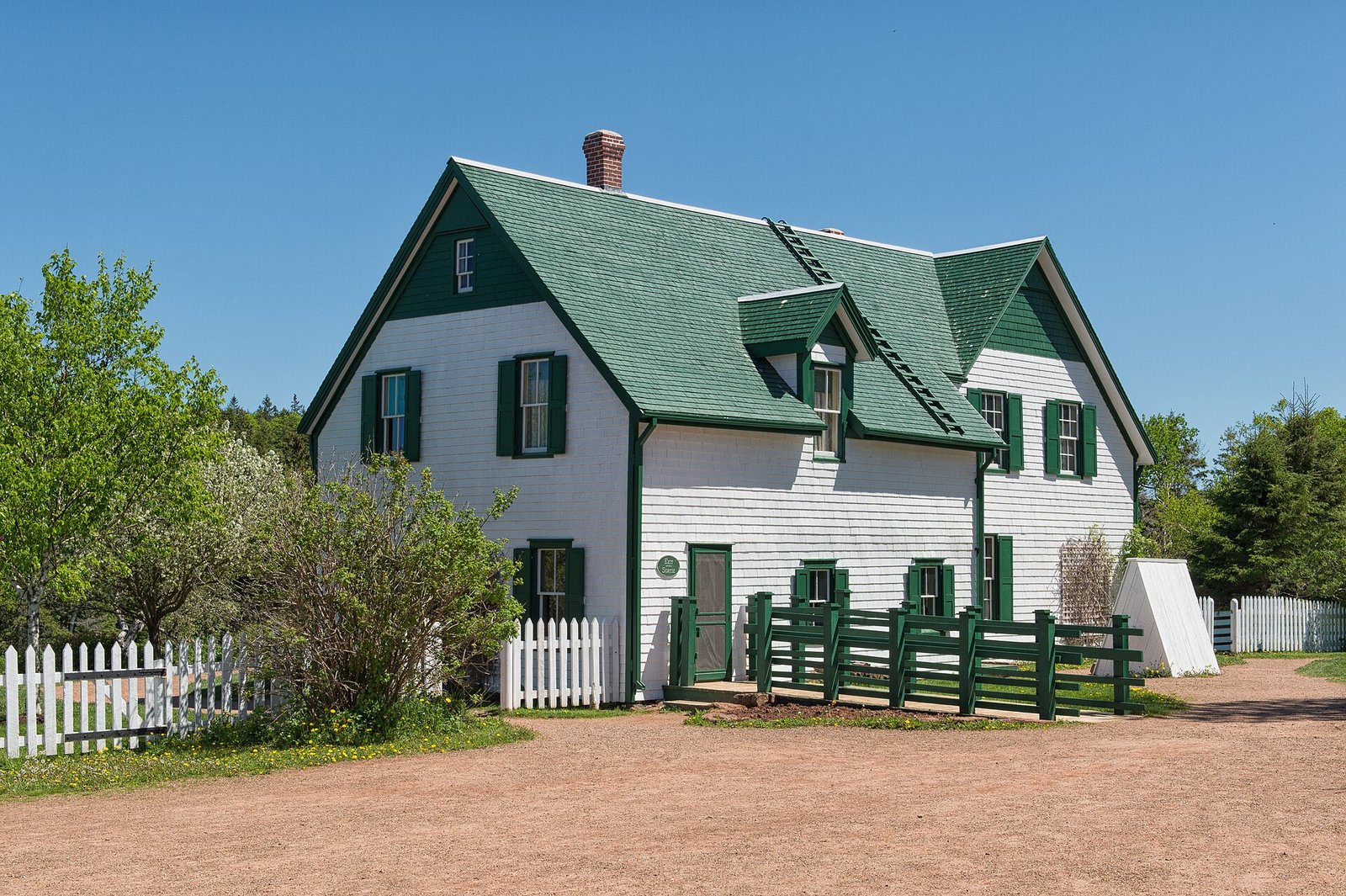 The white farmhouse with green gables and trim at Green Gables Heritage Place