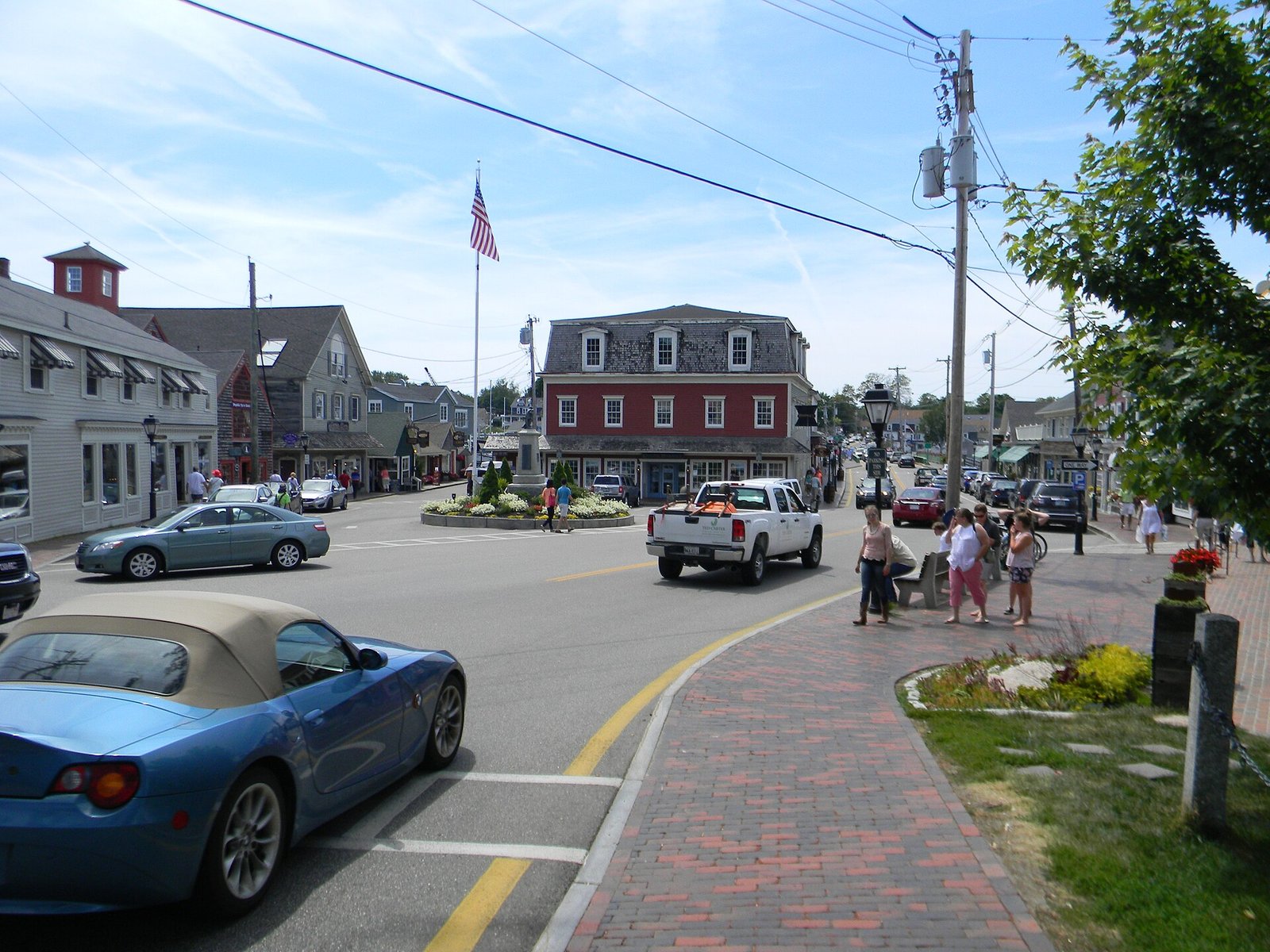 Dock Square in Kennebunkport, with shops and an American flag